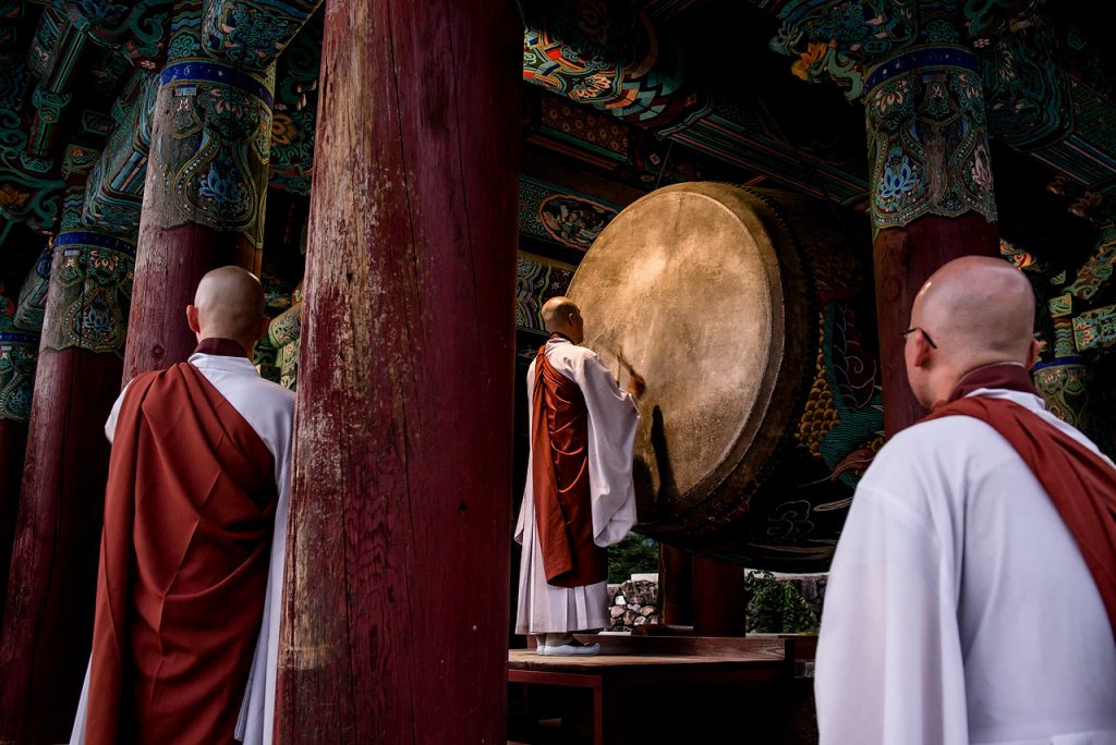 Buddhist monks watching a drum ceremony