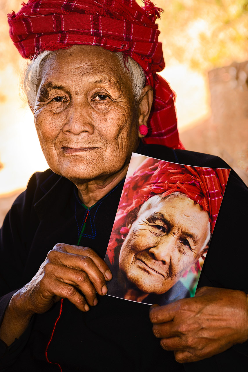 Woman with portrait in Myanmar