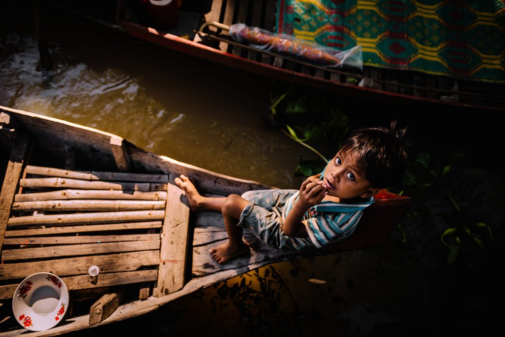 Boy on boat at Kampong Phluk