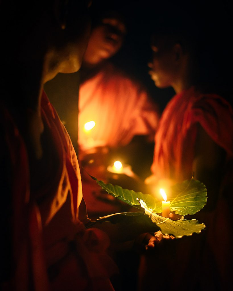 Buddhist monks with candles in the upper sanctuary of Angkor Wat