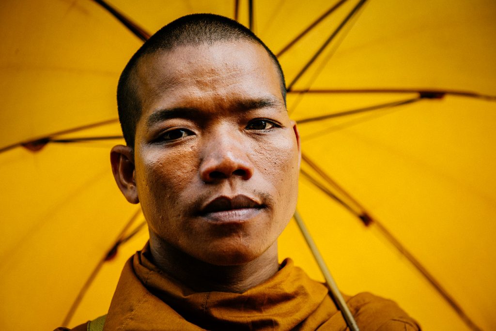 cambodian monk with umbrella